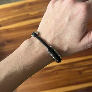 Silver hair tie bracelet including black hair tie. Brand new, never been worn.